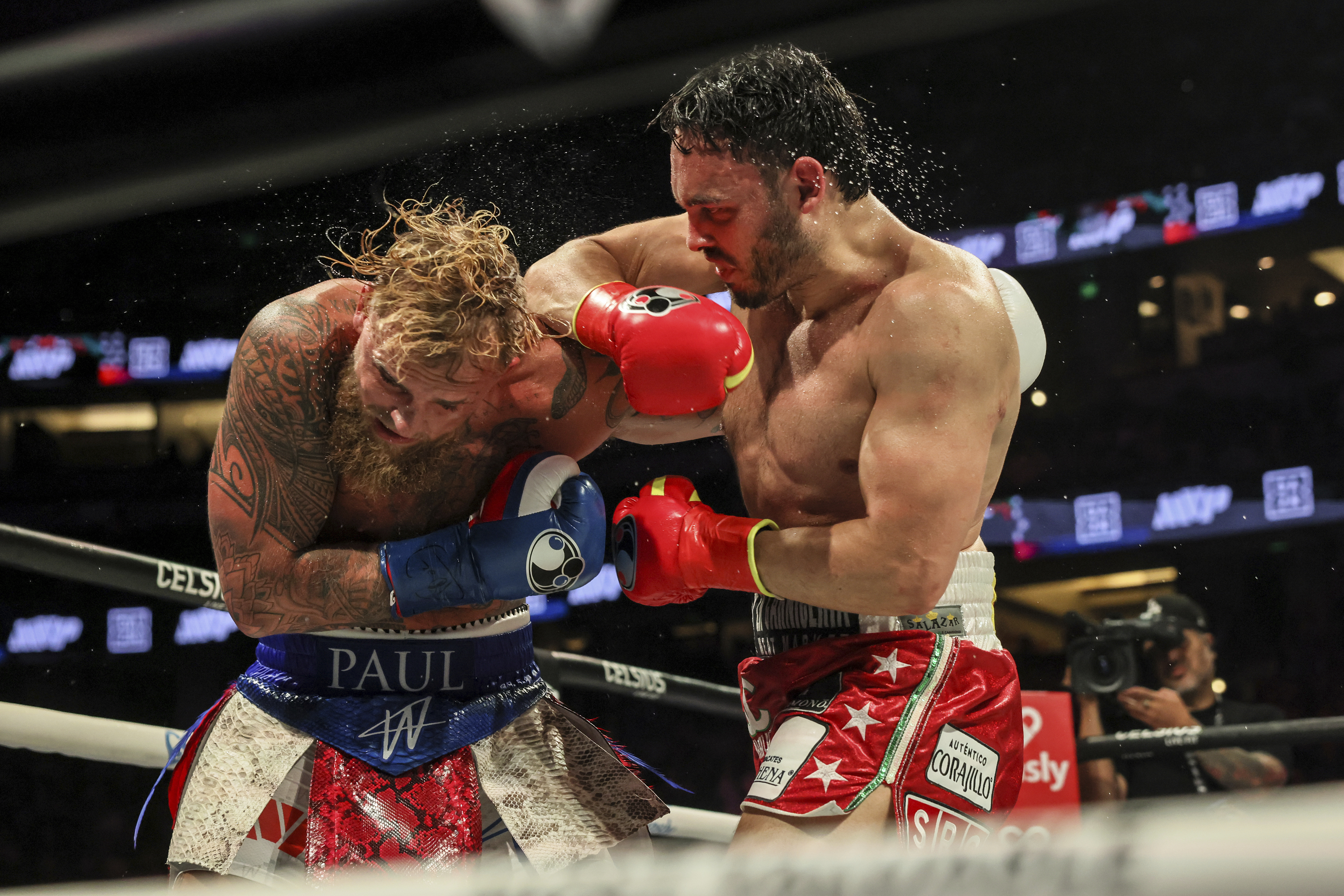 Julio Cesar Chavez Jr., right, punches Jake Paul during their cruiserweight boxing match on Saturday, June 28, 2025, in Anaheim, Calif. 