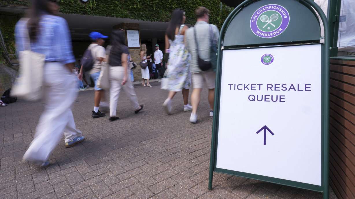 People pickup tickets at a Resale Office during the Wimbledon Tennis Championships in London, Thursday, July 3, 2025.