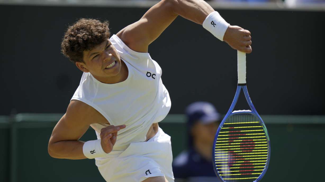 Ben Shelton of the U.S. serves to Rinky Hijikata of Australia during the men's singles second round match at the Wimbledon Tennis Championships in London, Friday, July 4, 2025.