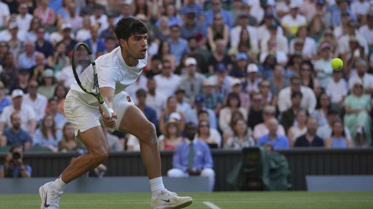 Carlos Alcaraz of Spain returns to Jan-Lennard Struff of Germany speeds past during a third round men's singles match at the Wimbledon Tennis Championships in London, Friday, July 4, 2025.