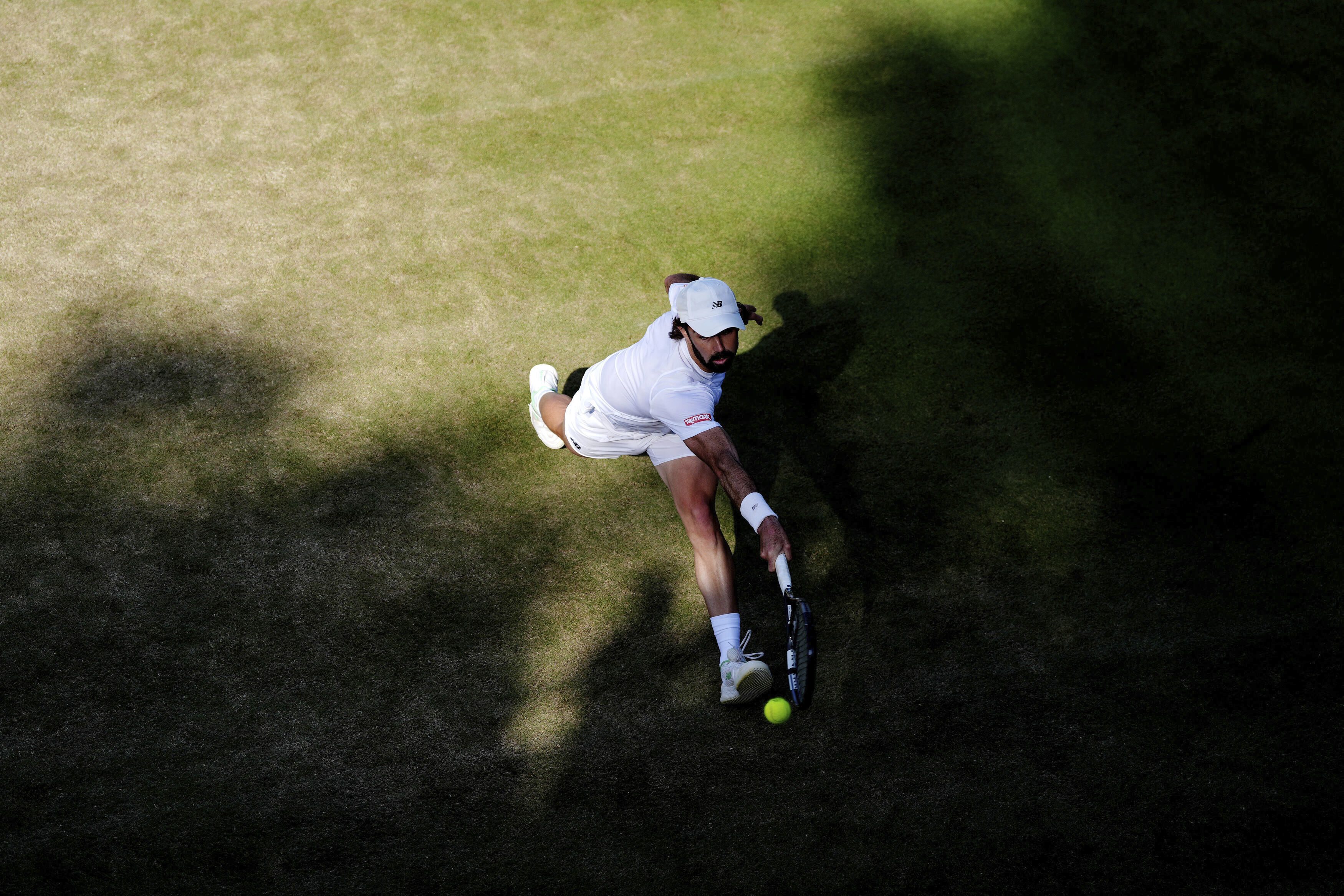Australia's Jordan Thompson returns during his match against Italy's Luciano Darderi during their men's singles third round match on day five of the Wimbledon Tennis Championships in London, Friday July 4, 2025. 