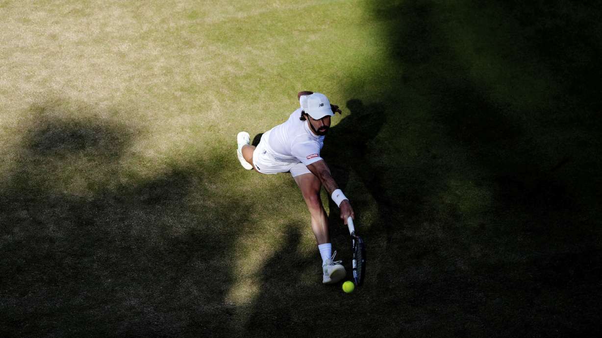 Australia's Jordan Thompson returns during his match against Italy's Luciano Darderi during their men's singles third round match on day five of the Wimbledon Tennis Championships in London, Friday July 4, 2025.