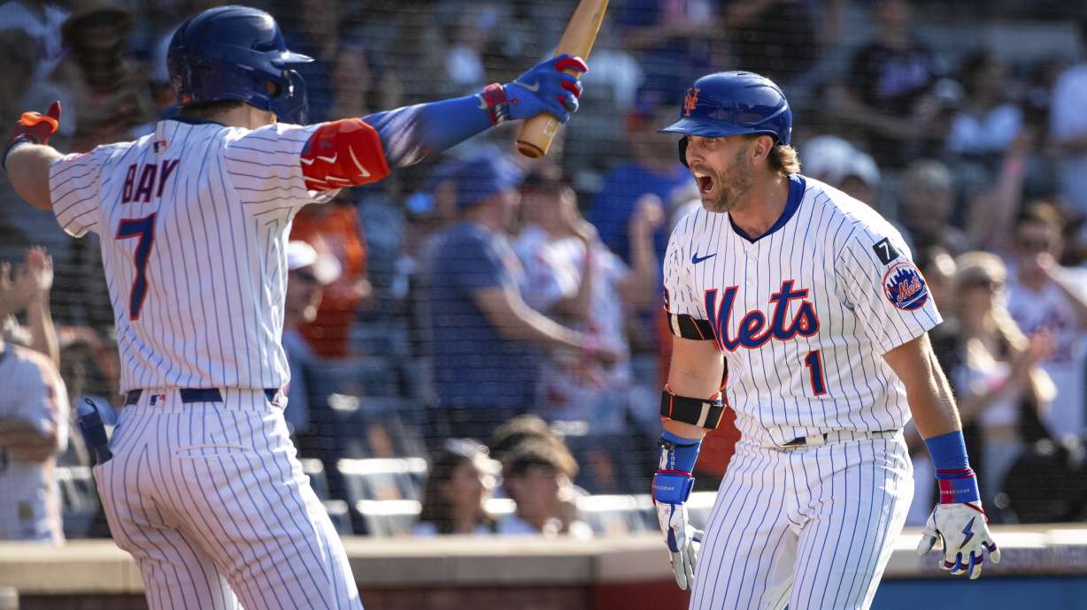 New York Mets' Jeff McNeil (1) celebrates with Brett Baty (7) after scoring on his two-run home run during the seventh inning of a baseball game against the New York Yankees, Friday, July 4, 2025, in New York.