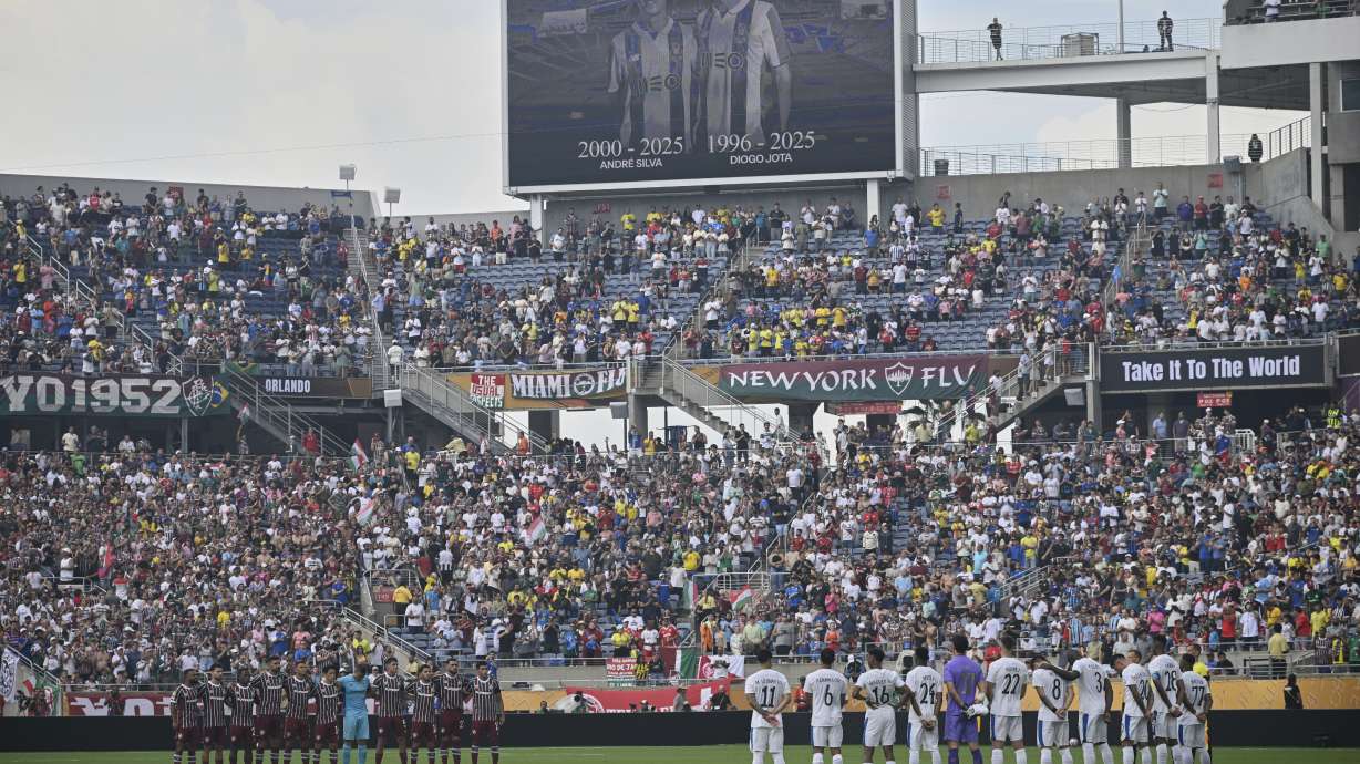 Players stand during a minute of silence for two soccer players who were killed in a car crash, Diogo Jota and his brother Andre Silva, before the Club World Cup quarterfinal soccer match between Fluminense and Al Hilal in Orlando, Fla., Friday, July 4, 2025.