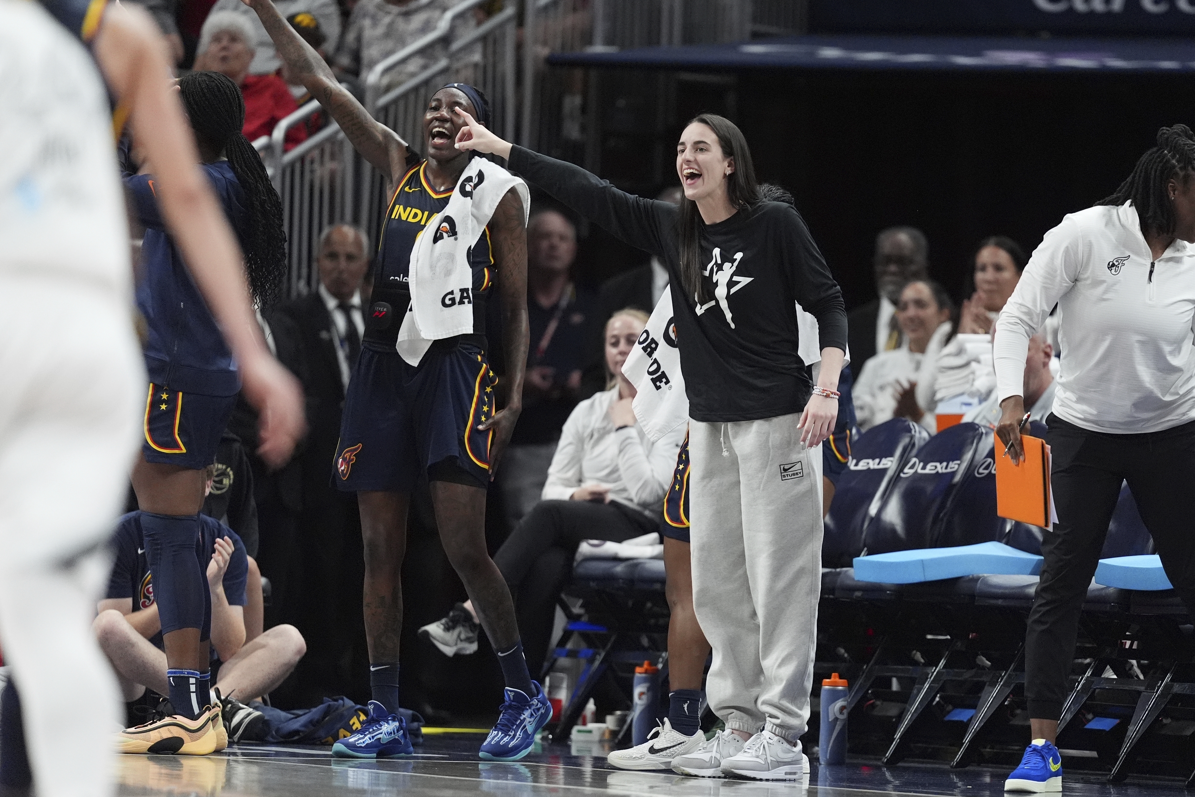 Indiana Fever's Caitlin Clark, center front, cheers during the second half of a WNBA basketball game against the Las Vegas Aces, Thursday, July 3, 2025, in Indianapolis. 