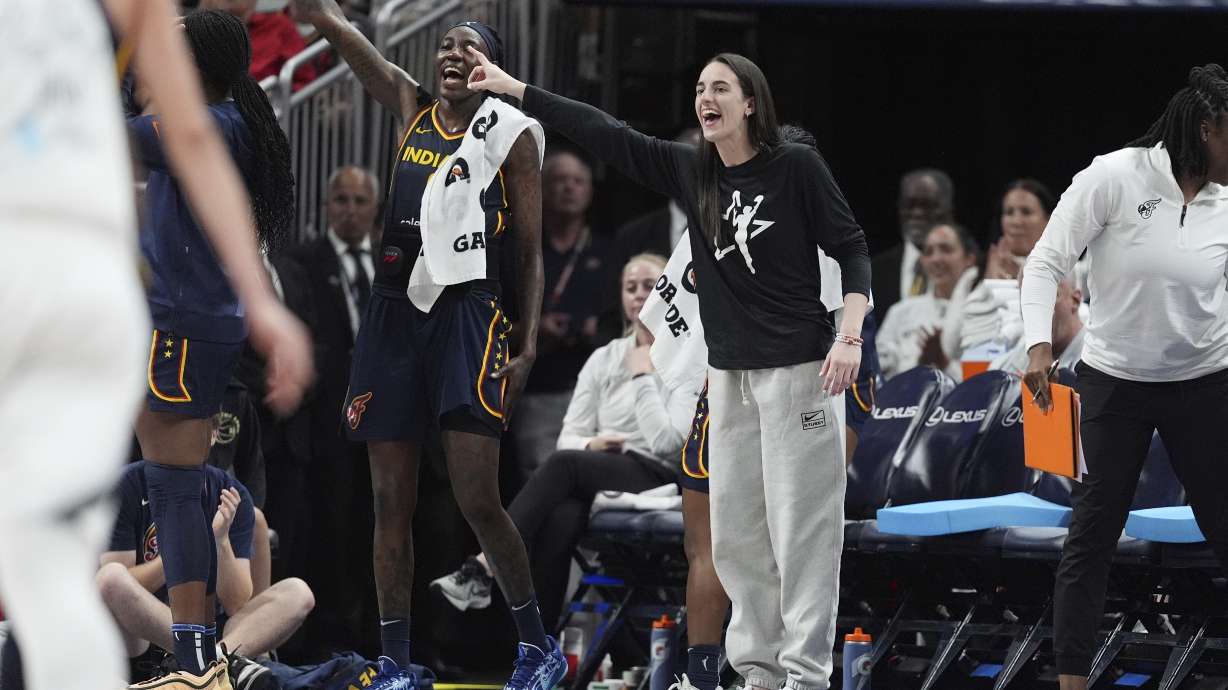Indiana Fever's Caitlin Clark, center front, cheers during the second half of a WNBA basketball game against the Las Vegas Aces, Thursday, July 3, 2025, in Indianapolis.