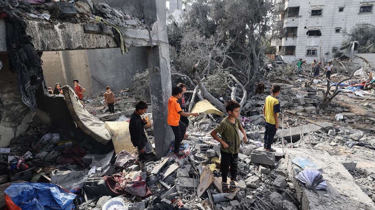 Palestinian children check the rubble in Deir el-Balah in the central Gaza Strip on Tuesday following overnight Israeli strikes. A ceasefire agreement could be reached in Gaza as early as next week.