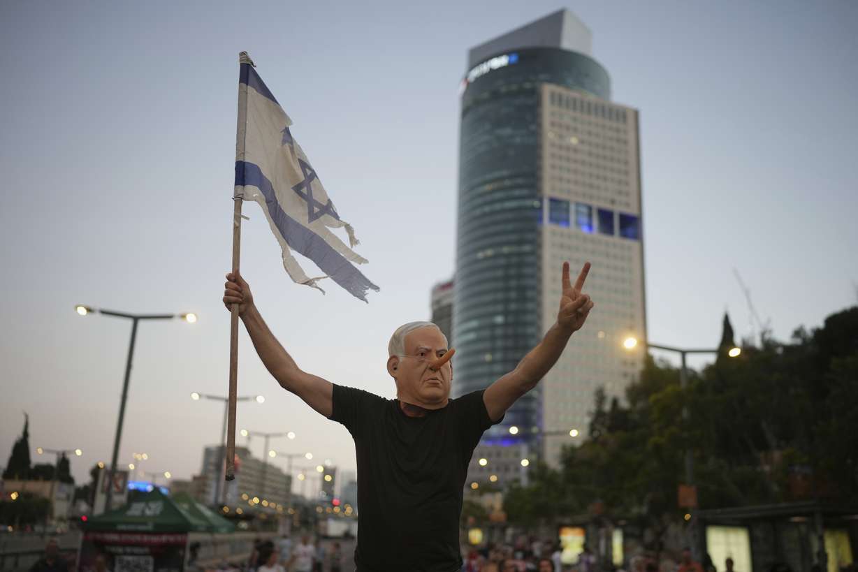 A demonstrator takes part in a protest against Prime Minister Benjamin Netanyahu's government and call for the release of hostages held in the Gaza Strip by Hamas, in Tel Aviv, Saturday. Netanyahu made a rhetorical shift in prioritizing hostage releases last weekend.