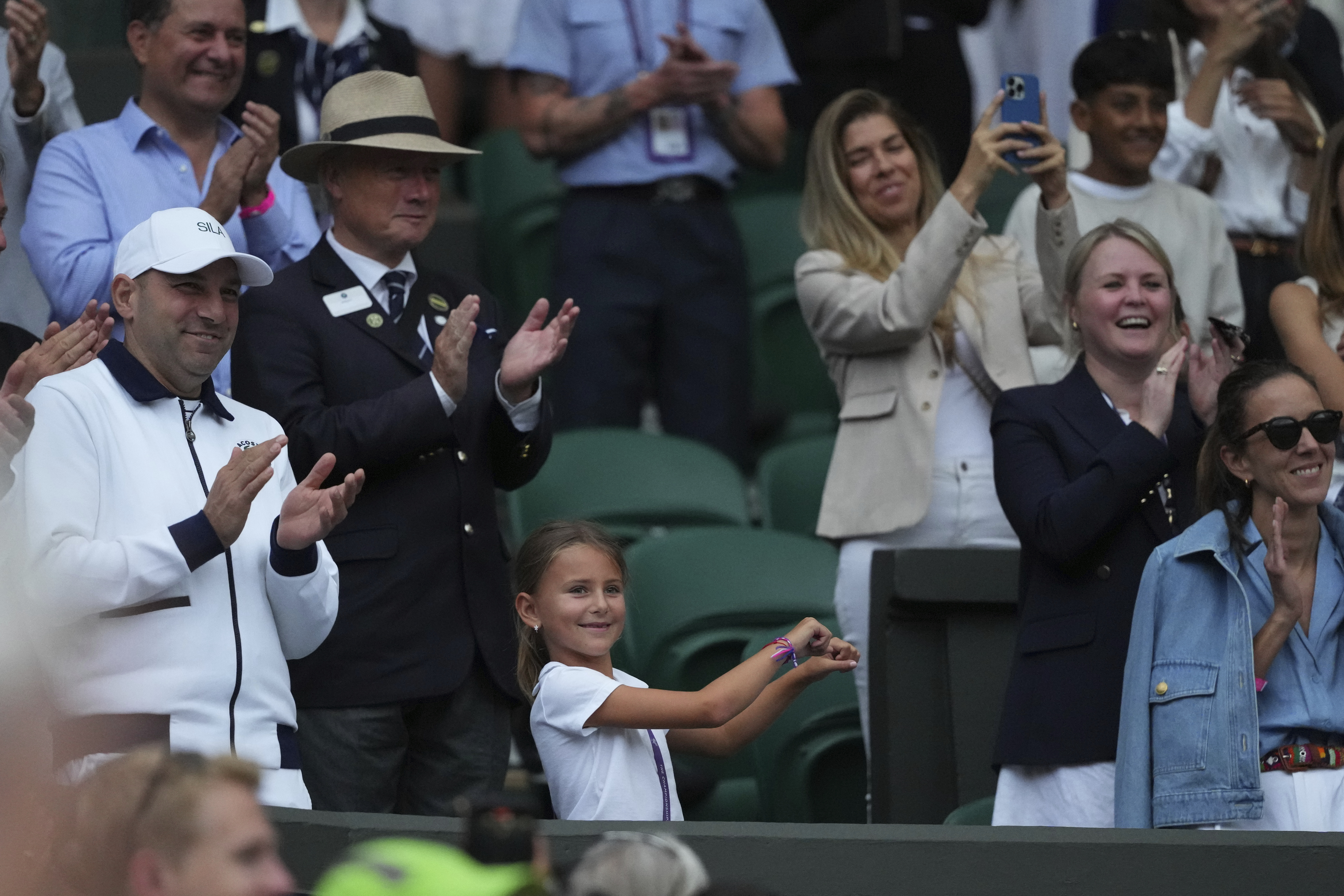 Tara, the daughter of Novak Djokovic of Serbia does a dance as she celebrates her father beating Miomir Kecmanovic of Serbia during a third round men's singles match at the Wimbledon Tennis Championships in London, Saturday, July 5, 2025.