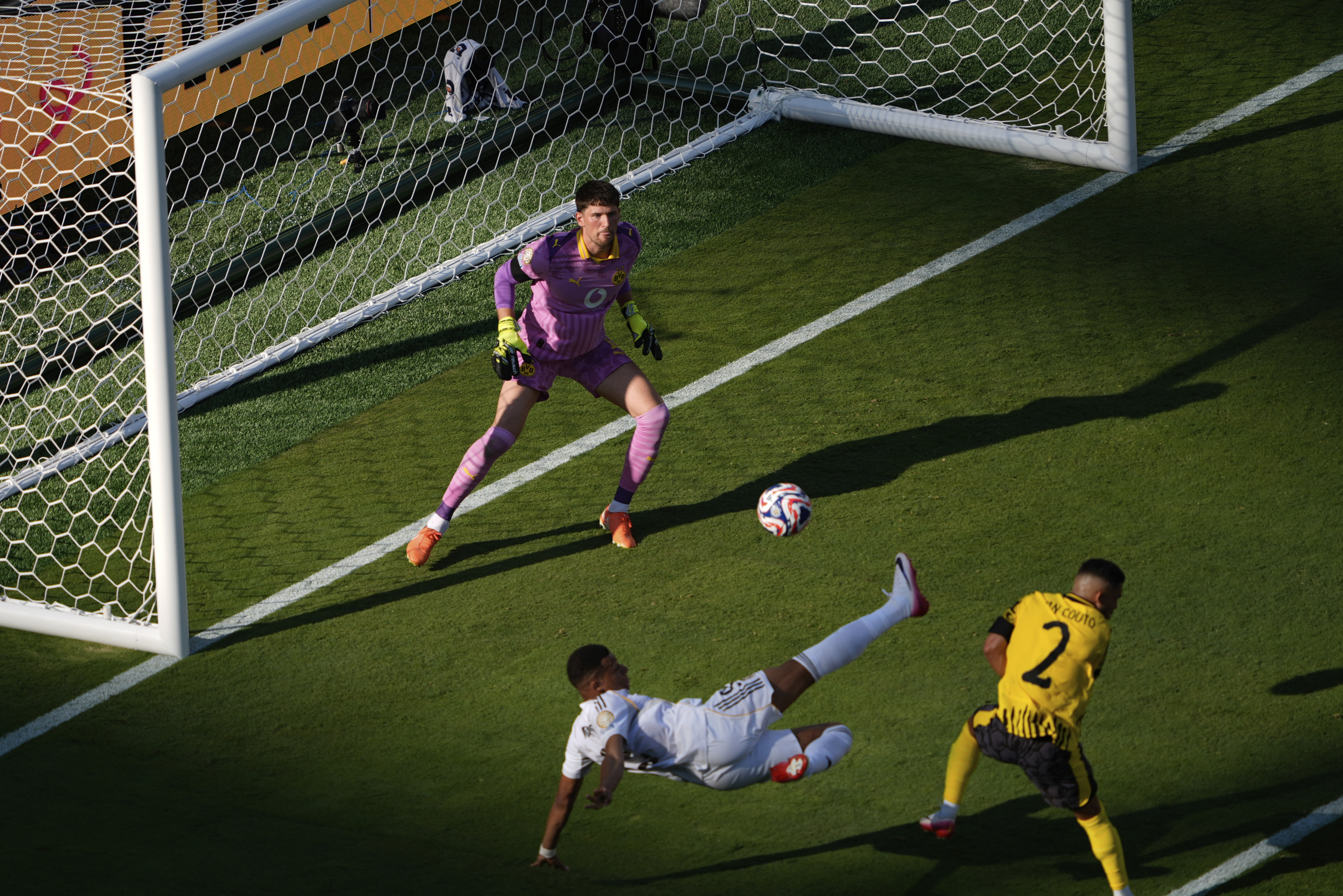 Real Madrid's Kylian Mbappe, bottom, scores his side's 3rd goal during the Club World Cup quarterfinal soccer match between Real Madrid and Borussia Dortmund in East Rutherford, N.J., Saturday, July 5, 2025. 