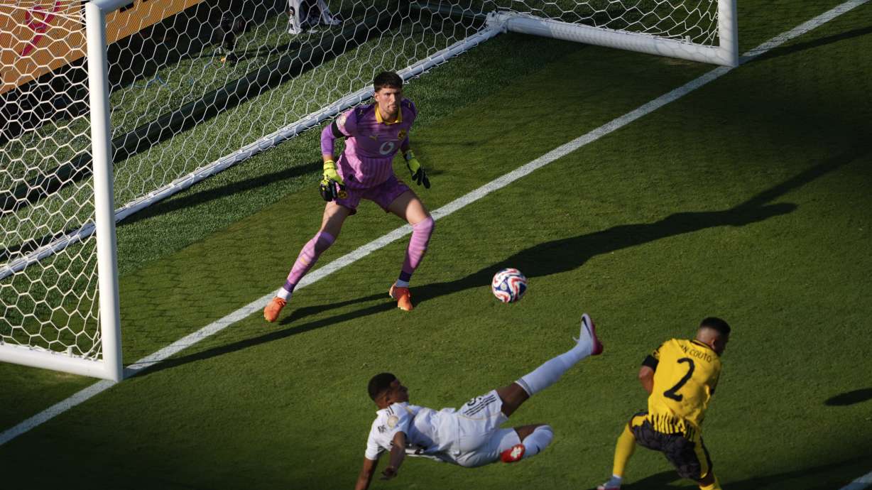 Real Madrid's Kylian Mbappe, bottom, scores his side's 3rd goal during the Club World Cup quarterfinal soccer match between Real Madrid and Borussia Dortmund in East Rutherford, N.J., Saturday, July 5, 2025.