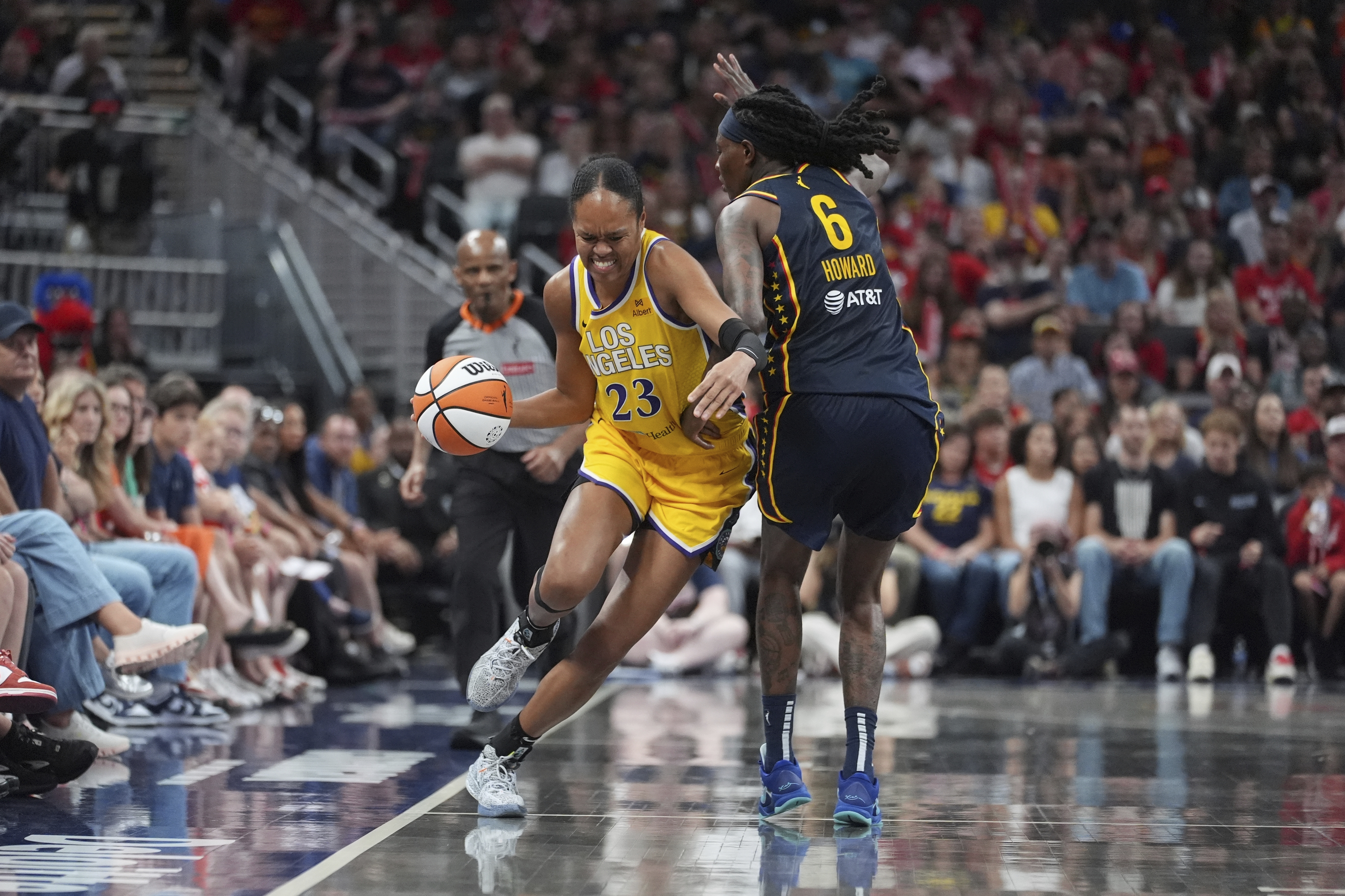 Los Angeles Sparks' Azura Stevens (23) goes by Indiana Fever's Natasha Howard (6) during the second half of a WNBA basketball game, Saturday, July 5, 2025, in Indianapolis.