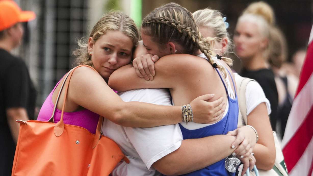 Campers embrace as girls from Camp Waldemar are reconnected with their families after heavy rainfall in central Texas, Saturday. Flash floods have killed at least 51 people in the area, with 27 girls from Camp Mystic still missing.