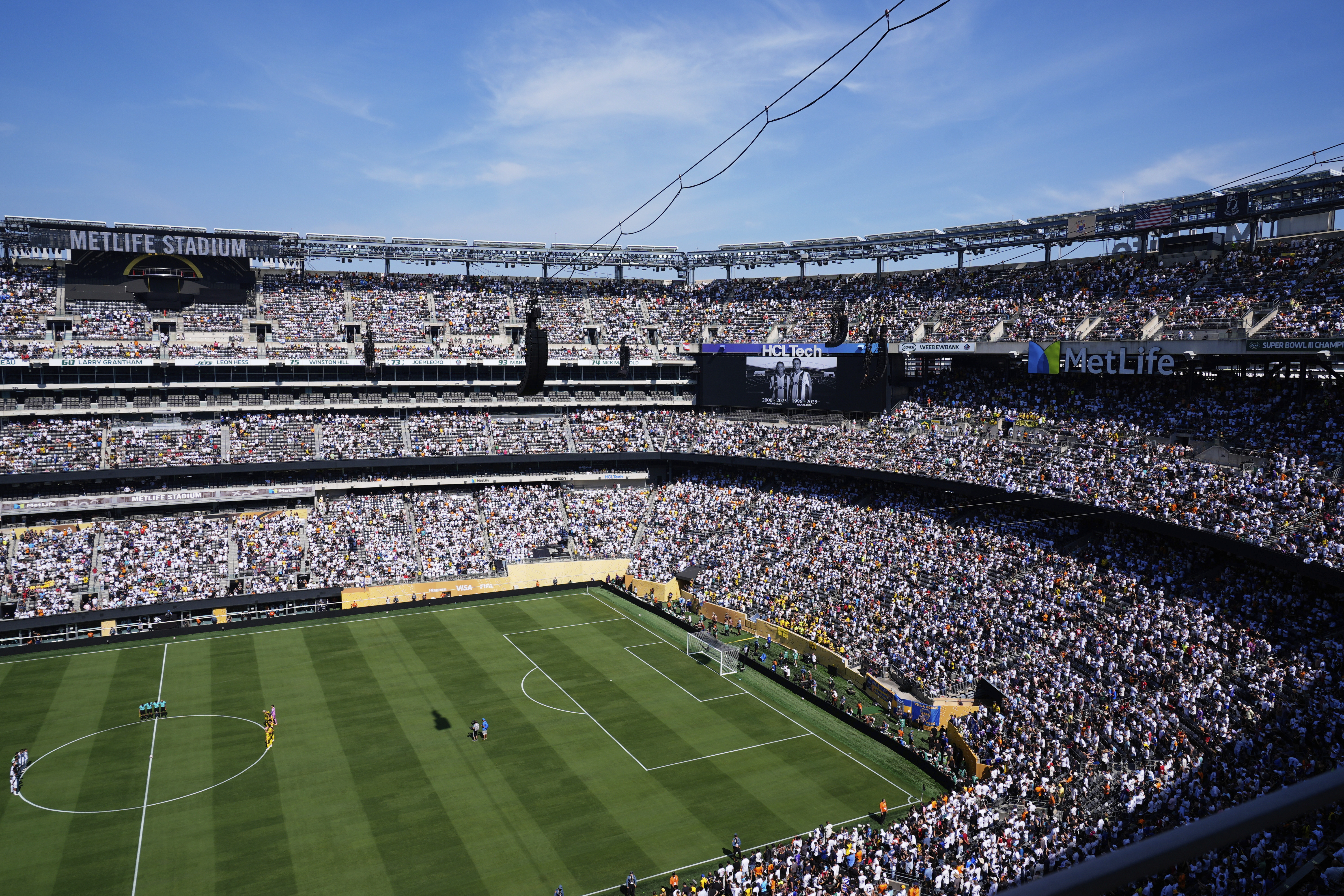 Players and fans observe a minute of silent in memory of Portugal international and Liverpool player Diogo Jota and his brother Andre Silva prior the Club World Cup quarterfinal soccer match between Real Madrid and Borussia Dortmund in East Rutherford, N.J., Saturday, July 5, 2025. 