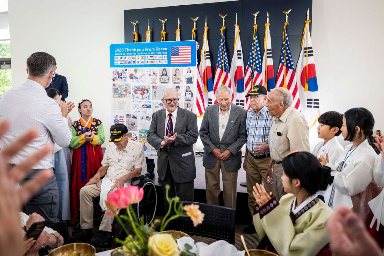 The audience claps for Korean War veterans, from left, Robert Young, of Cottonwood Heights, Arthur Arvanitas, of Salt Lake City, Glen Olsen of Cottonwood Heights, Jim Crane, of Salt Lake City, and John “Jack” Buckmiller, of Holladay, as they are presented with a banner of thanks from the Pumassi — Little Ambassadors during a sister city welcome and celebration dinner for the bond between Cottonwood Heights, Utah, and Incheon, Yeonsu-gu, South Korea, held at the Cottonwood Heights City Hall on Saturday.