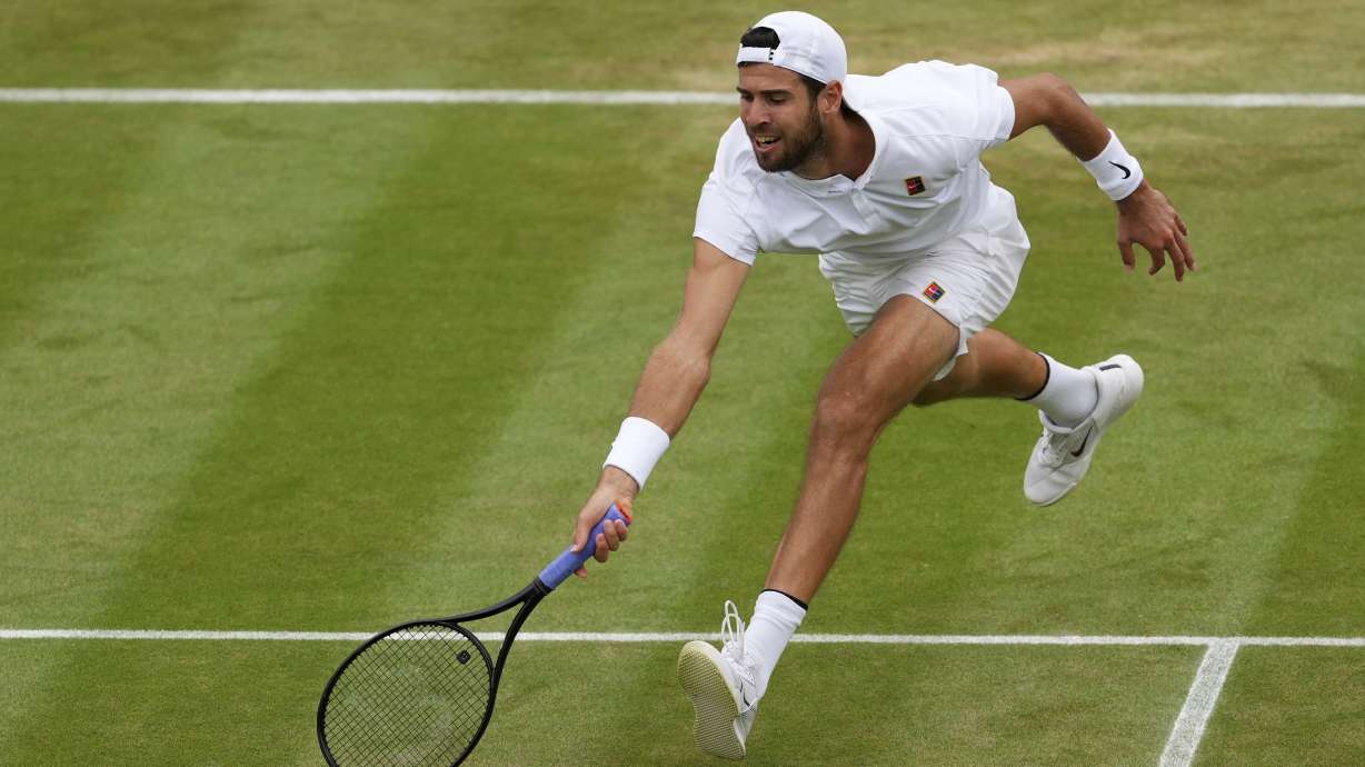 Karen Khachanov of Russia plays a return to Kamil Majchrzak of Poland during their men's singles fourth round match at the Wimbledon Tennis Championships in London, Sunday, July 6, 2025.