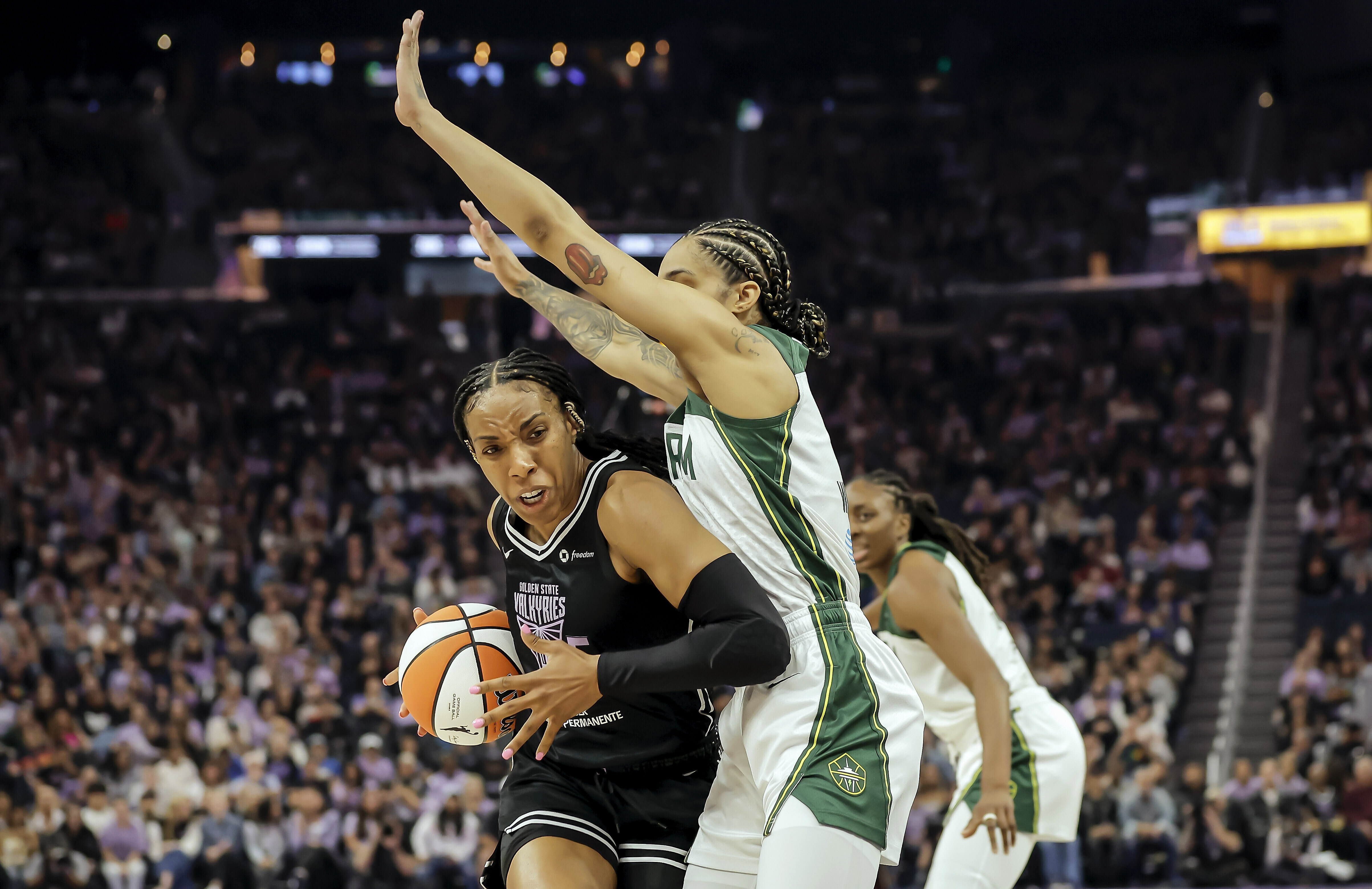Golden State Valkyries' Kayla Thornton, left, drives to the basket in the first half of a WNBA basketball game against the Seattle Storm in San Francisco, Sunday, June 29, 2025.