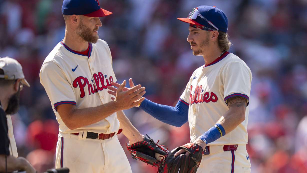 Philadelphia Phillies' Zack Wheeler, left, celebrates with Bryson Stott, right, following a baseball game against the Cincinnati Reds, Sunday, July 6, 2025, in Philadelphia.