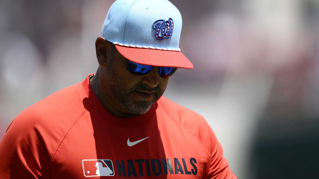 Washington Nationals manager Dave Martinez wears a patriotic themed cap as he walks back to the dugout after a pitching change during the fifth inning of a baseball game against the Boston Red Sox, Friday, July 4, 2025, in Washington.