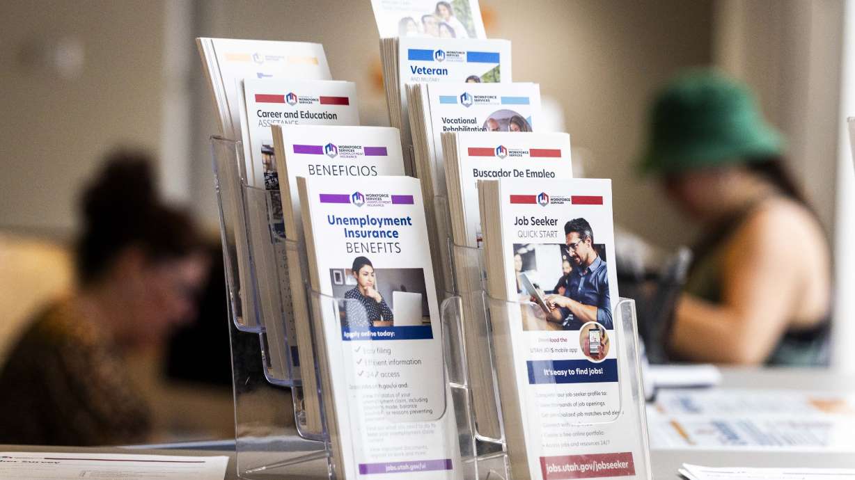 Pamphlets are pictured while a person talks with a worker at the Utah Department of Workforce Services in Taylorsville on Thursday. A new Deseret News poll found Utah voters are mixed on local versus national fiscal health.