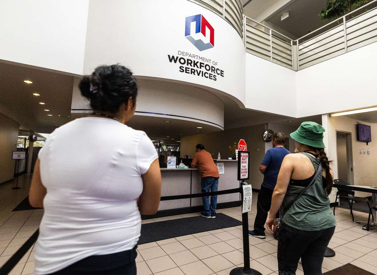 People wait in line at the Utah Department of Workforce Services in Taylorsville on Thursday. A new Deseret News poll found Utah voters are mixed on local versus national fiscal health.