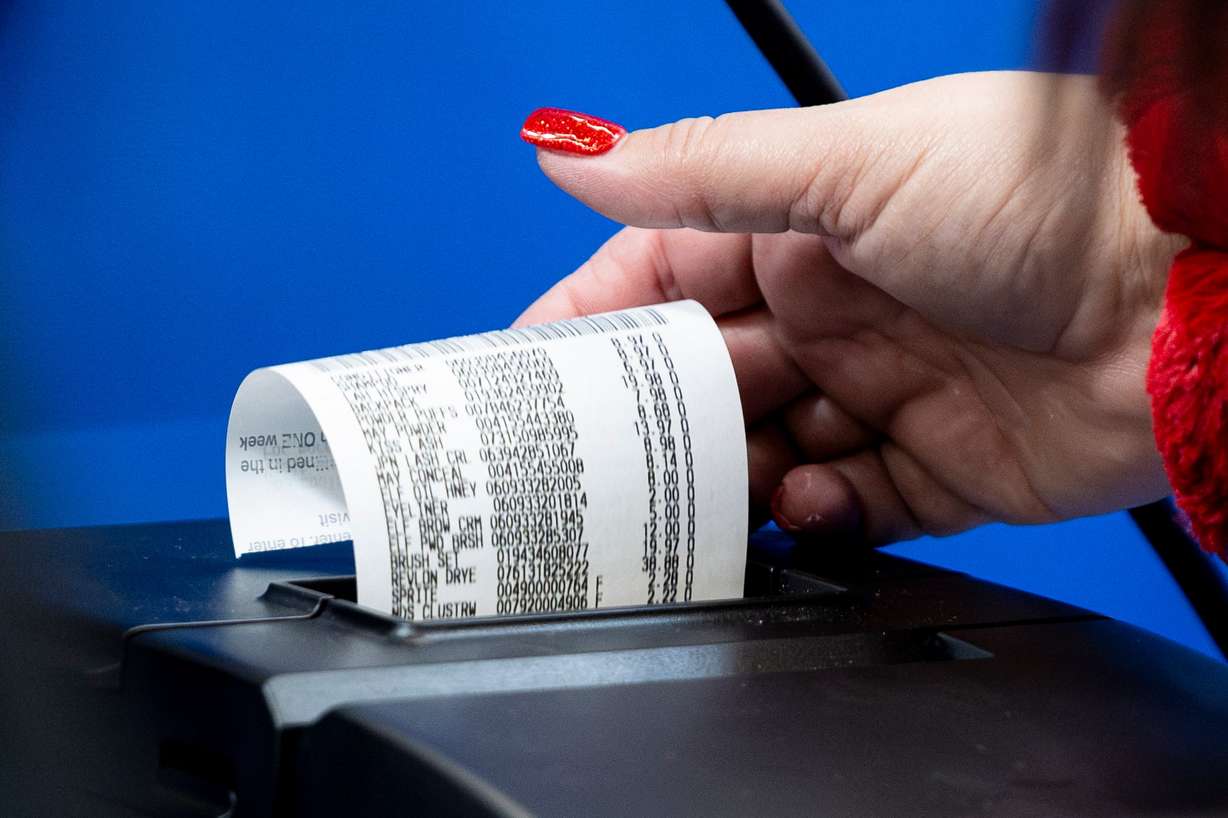 A cashier prints a receipt at the South Jordan Parkway Walmart on Dec. 7, 2024. A new Deseret News poll found voters are mixed on local versus national fiscal health.