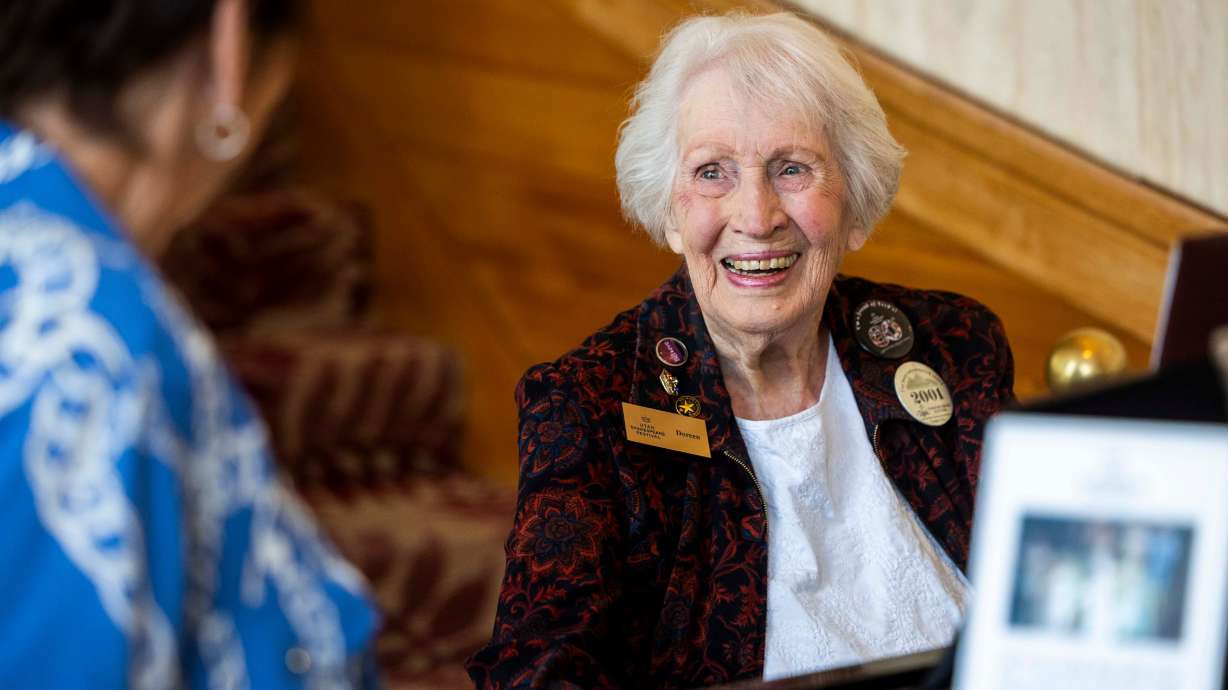 Doreen Woolley laughs with a passing theatergoer while playing the piano for arriving audience members in the lobby of the Randall L. Jones Theatre before a theatrical performance at the Utah Shakespeare Festival in Cedar City on June 20.