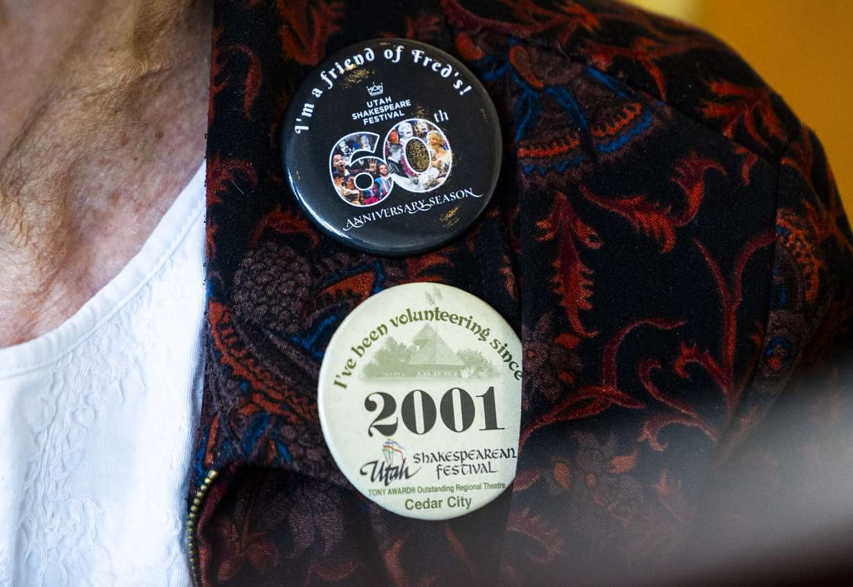 Shakespeare Festival pins adorn Doreen Woolley’s shirt as she plays the piano for arriving audience members in the lobby of the Randall L. Jones Theatre before a theatrical performance at the Utah Shakespeare Festival in Cedar City on June 20.