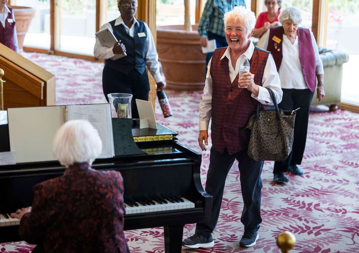 Festival volunteer Ellen Boyer, right, smiles while listening to Doreen Woolley play the piano in the lobby of the Randall L. Jones Theatre before a theatrical performance at the Utah Shakespeare Festival in Cedar City on June 20.