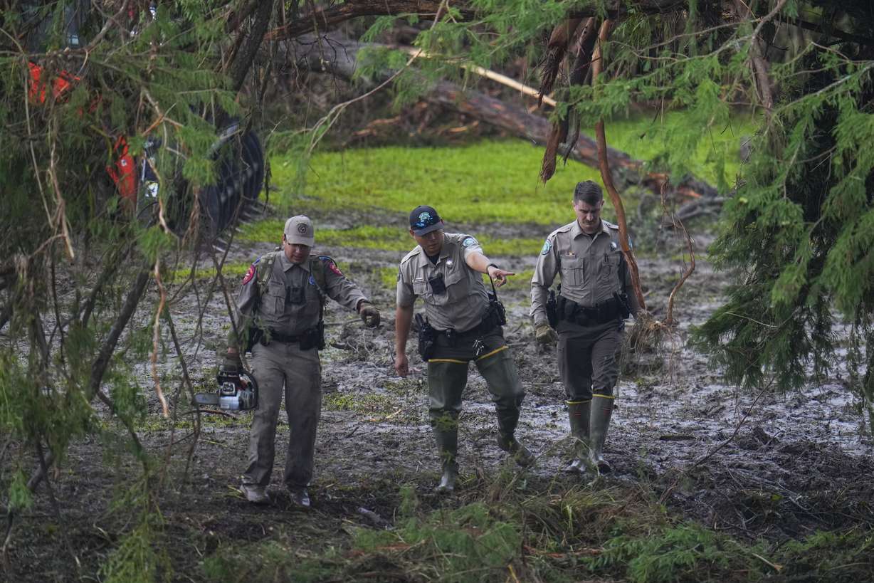 Officials inspect an area at Camp Mystic along the banks of the Guadalupe River after a flash flood swept through the area Sunday in Hunt, Texas.