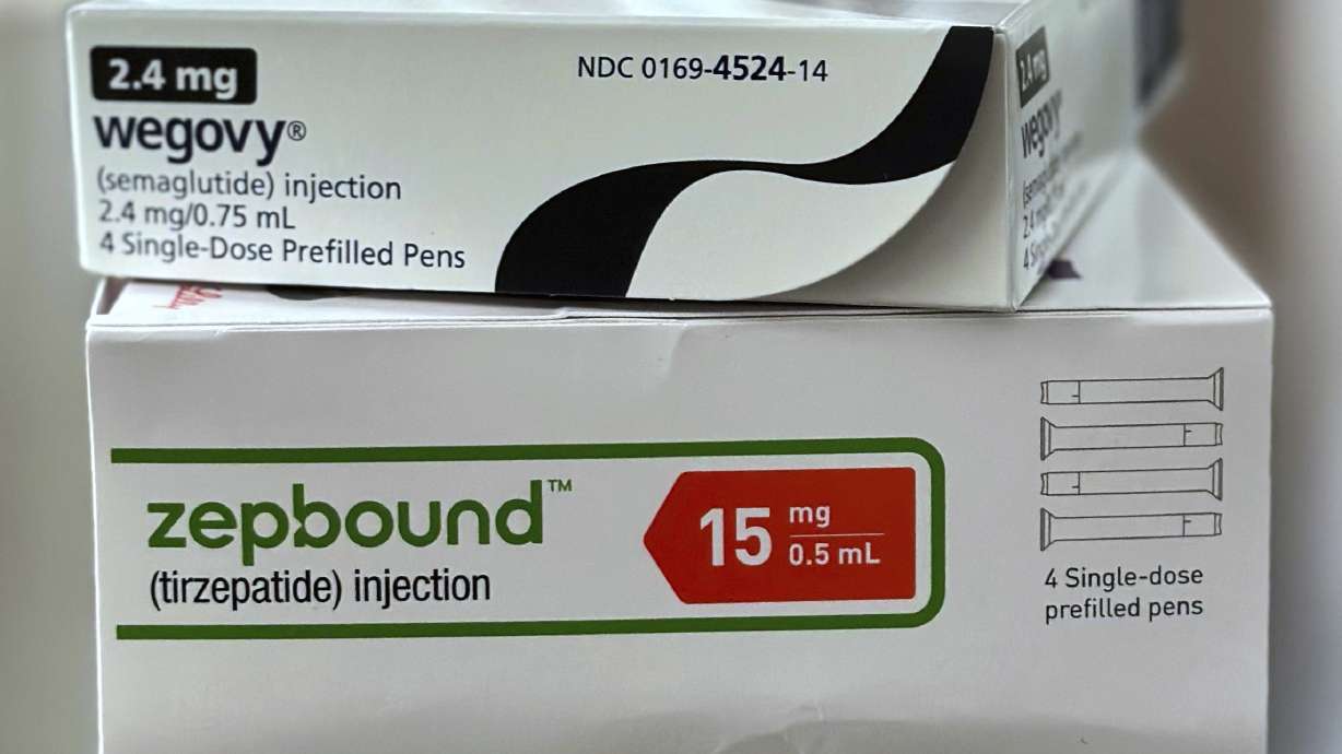 Boxes for the medications Wegovy and Zepbound are arranged for a photograph in California on May 8. Obesity drug prices are falling, but many people still can't get them.