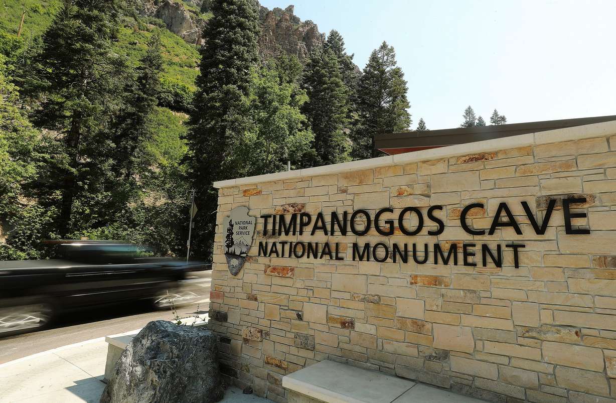 A motorist drives past the Timpanogos Cave National Monument sign in American Fork Canyon, July 21, 2020.