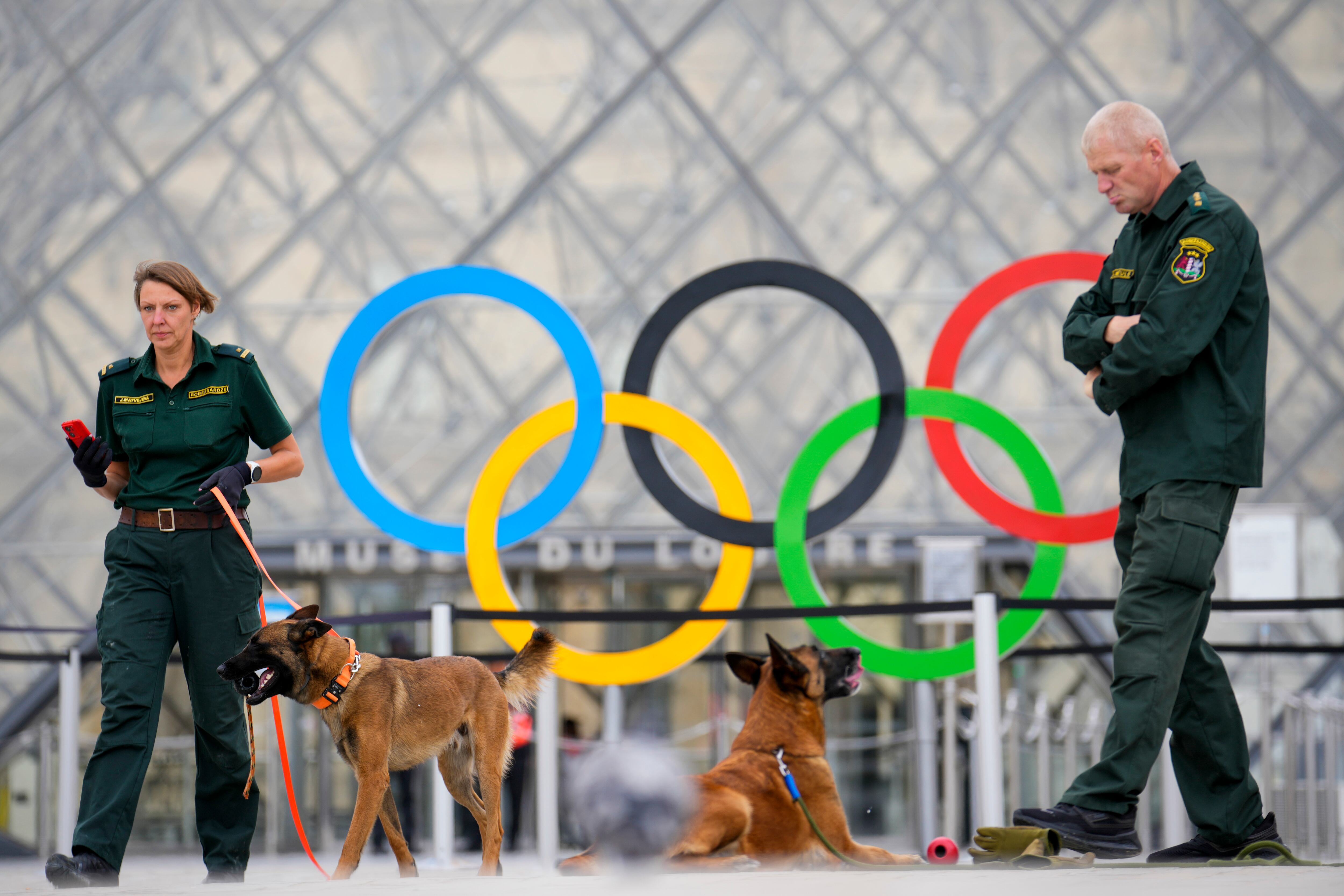 Security patrol the square near the Louvre Museum in Paris, France, ahead of the opening ceremony of the 2024 Summer Olympics, July 26, 2024.