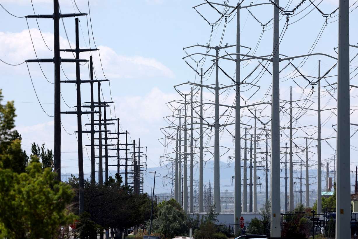High-tension power lines run along Wright Brothers Drive near the Salt Lake City International Airport in Salt Lake City on Tuesday, May 24, 2022.