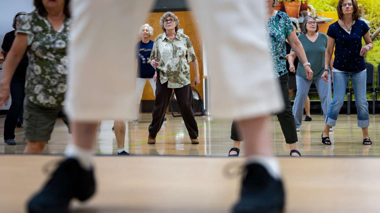 People participate in a line dancing class taught by Bonnie Heath, front, at the Murray City Senior Recreation Center in Murray on July 1.