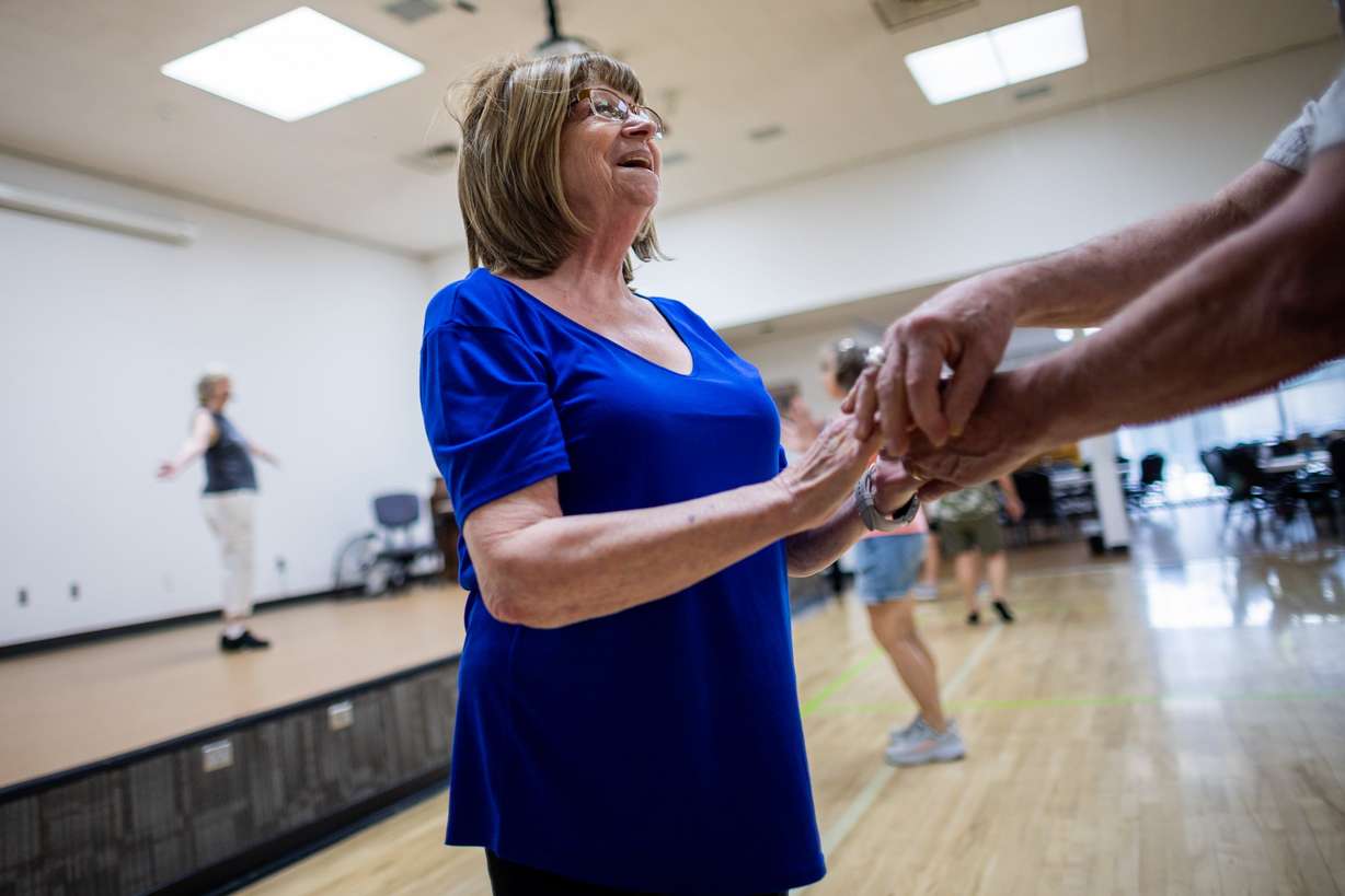 Linda Wood, left, and Roland Wood, off camera, participate in a line dancing class at the Murray City Senior Recreation Center in Murray on July 1.