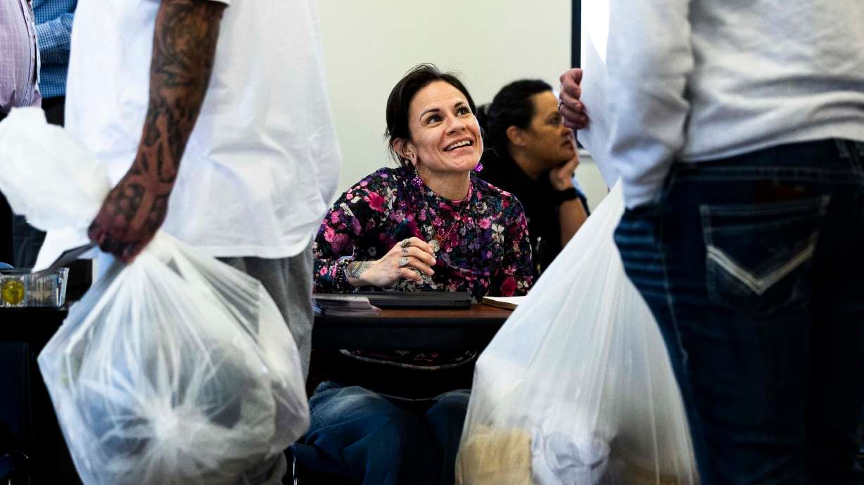 Channae Haller talks with people released from prison on release day at the Utah State Correctional Facility in Salt Lake City on Tuesday, April 8.