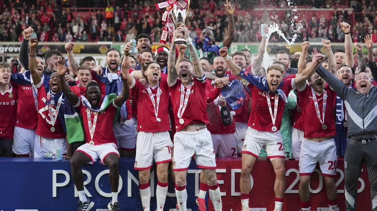 FILE - Wrexham players celebrate after winning the English League One soccer match between Wrexham and Charlton Athletic at the Racecourse ground in Wrexham, Wales, April 26, 2025.