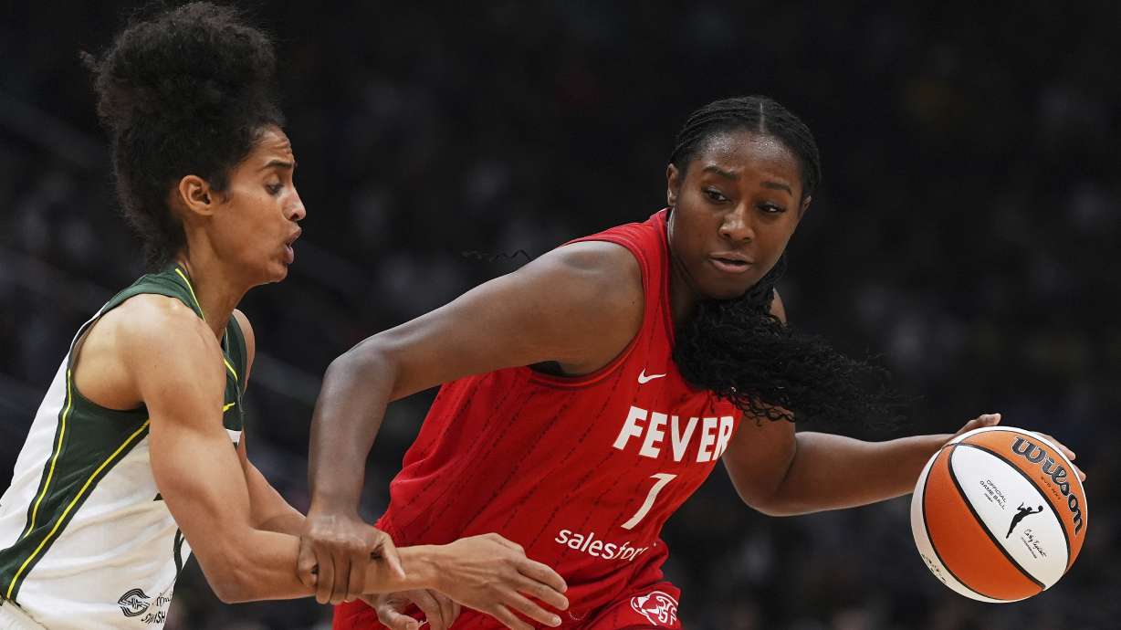 Indiana Fever forward Aliyah Boston (7) drives to the basket against Seattle Storm guard Skylar Diggins, left, during the first half of a WNBA basketball game Tuesday, June 24, 2025, in Seattle.