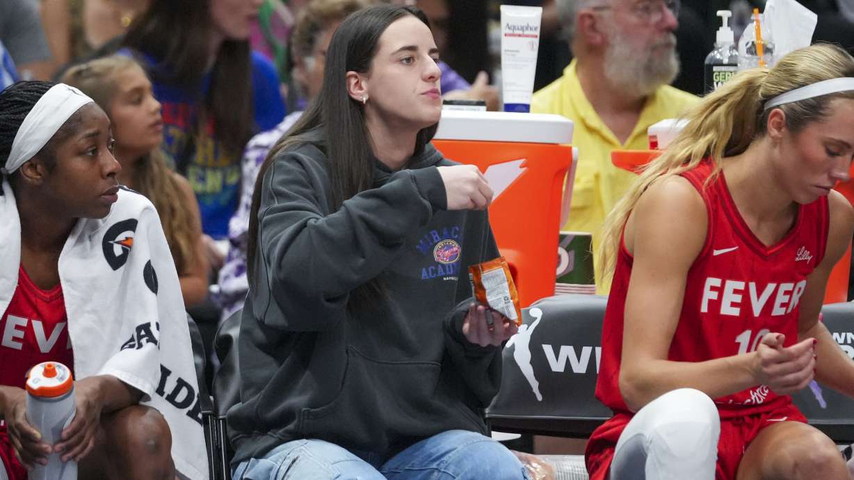 Indiana Fever guard Caitlin Clark eats Goldfish crackers during the first half of a WNBA basketball game against the Dallas Wings Friday, June 27, 2025, in Dallas.
