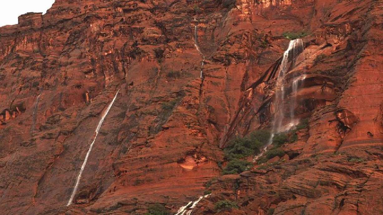 Post-monsoon waterfalls run down the red cliffs in the Snow Canyon State Park/Ivins area, Ivins, in southern Utah, Aug. 11, 2024.