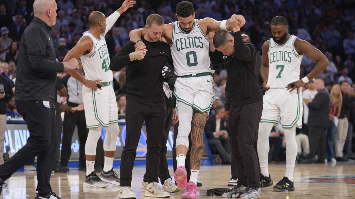 FILE - Trainers help Boston Celtics' Jayson Tatum (0) off the court after he was injured during the second half of Game 4 in the Eastern Conference semifinals of the NBA basketball playoffs against the New York Knicks, May 12, 2025, in New York.