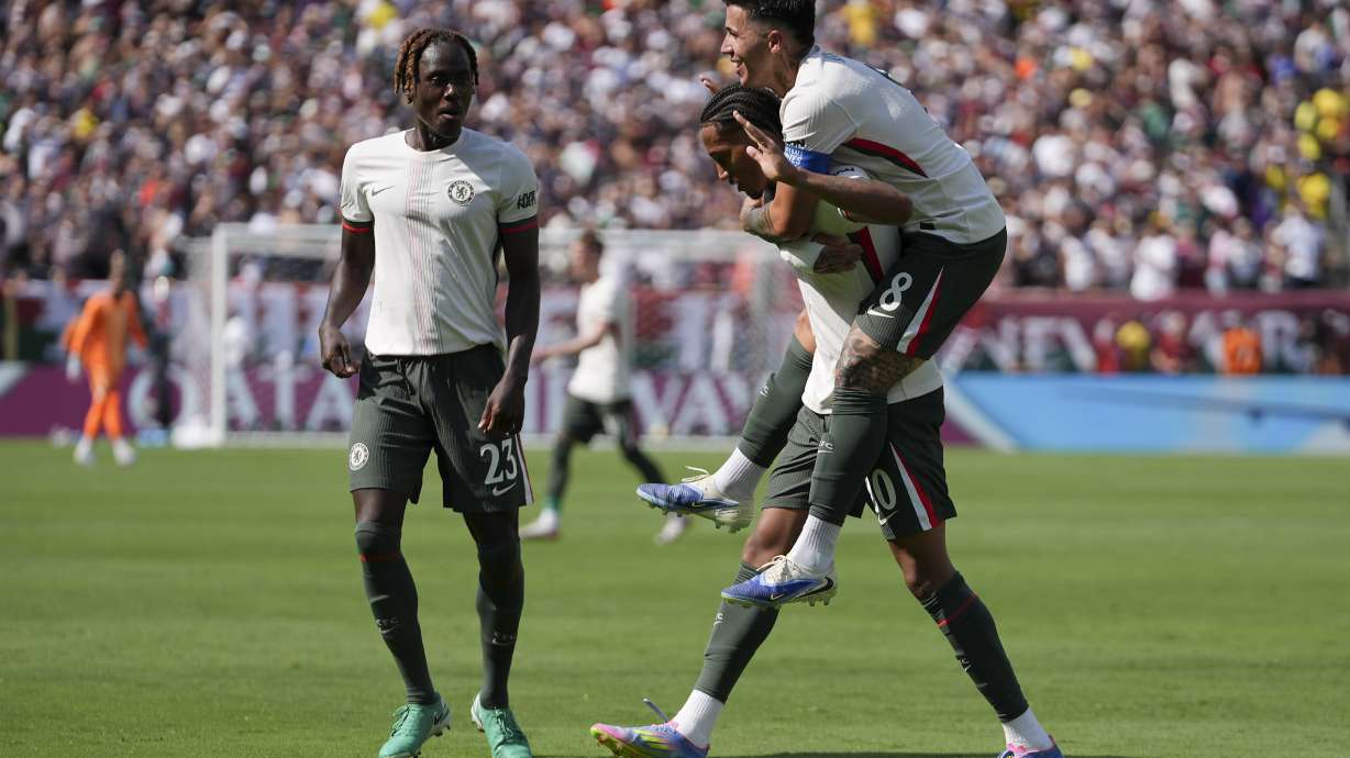 Chelsea's Joao Pedro celebrates with Enzo Fernandez, right, and Trevoh Chalobah, left, after scoring a goal against Fluminense during the second half of a Club World Cup semifinal soccer match in East Rutherford, N.J., Tuesday, July 8, 2025.