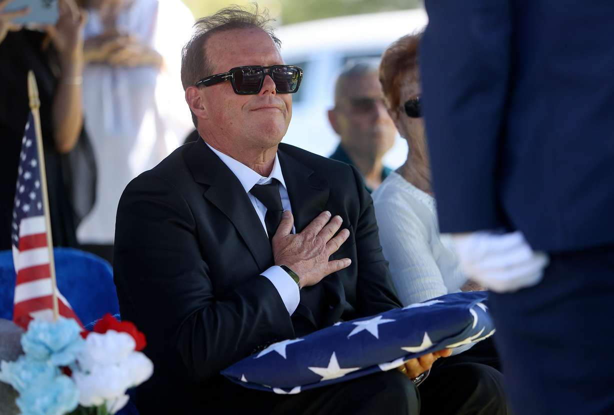 Brian Wilson receives the burial flag at the interment for his grandfather, 1st Lt. George Wilson, at Bountiful City Cemetery on Tuesday. The sentiments at the service reflected love and gratitude.