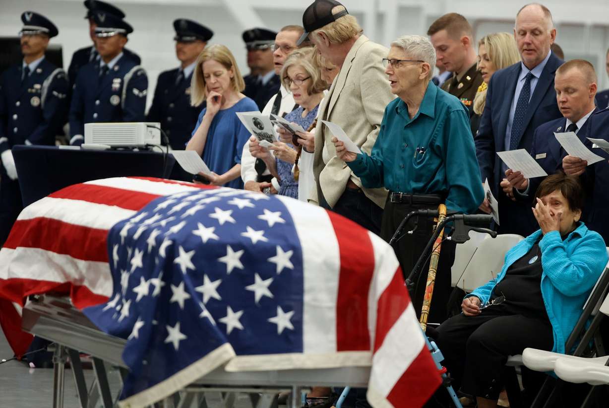 People sing at the memorial service for 1st Lt. George Wilson at the Hill Aerospace Museum on Tuesday. The sentiments at the service reflected love and gratitude.