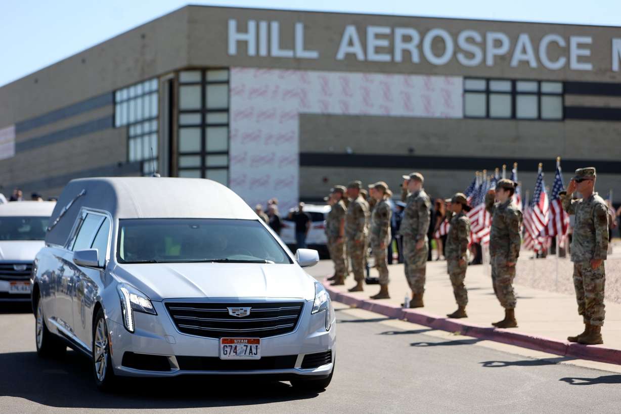 Service members salute the hearse carrying 1st Lt. George Wilson outside of the Hill Aerospace Museum on Tuesday. Wilson's remains arrived in Utah only a few days ago.