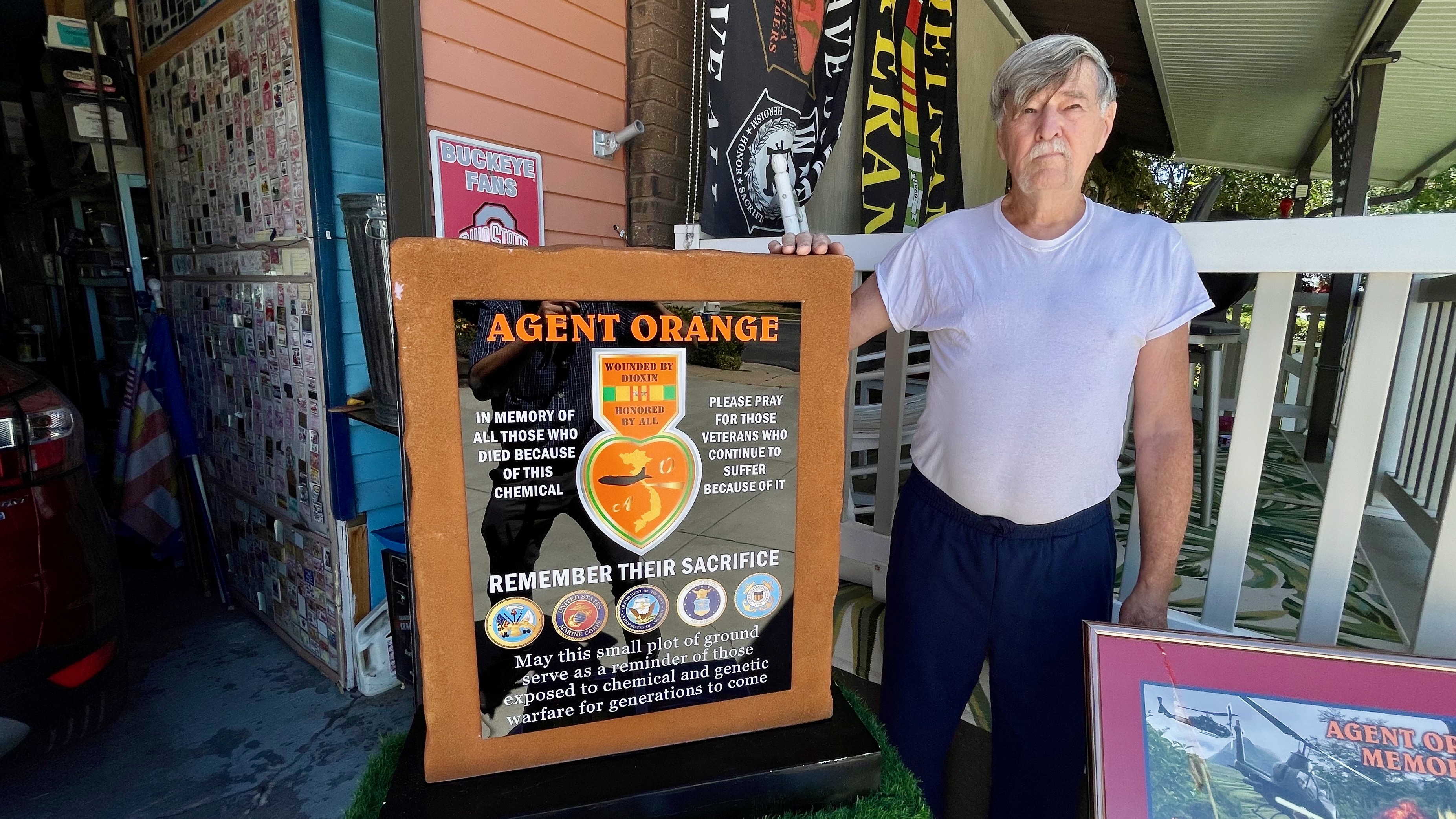 Larry Kerr, of Syracuse, pictured at his home on Tuesday, seeks installation in Utah of a memorial to victims of Agent Orange from the Vietnam War. He's pictured with a smaller version of the memorial he envisions.