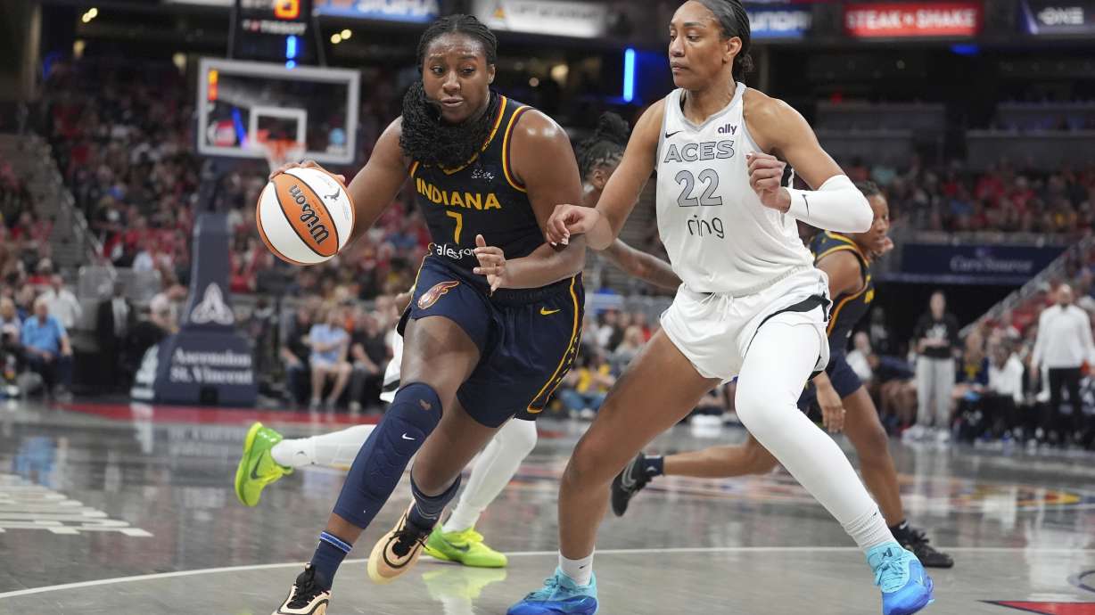 Indiana Fever's Aliyah Boston (7) goes to the basket against Las Vegas Aces' A'ja Wilson (22) during the first half of a WNBA basketball game, Thursday, July 3, 2025, in Indianapolis.
