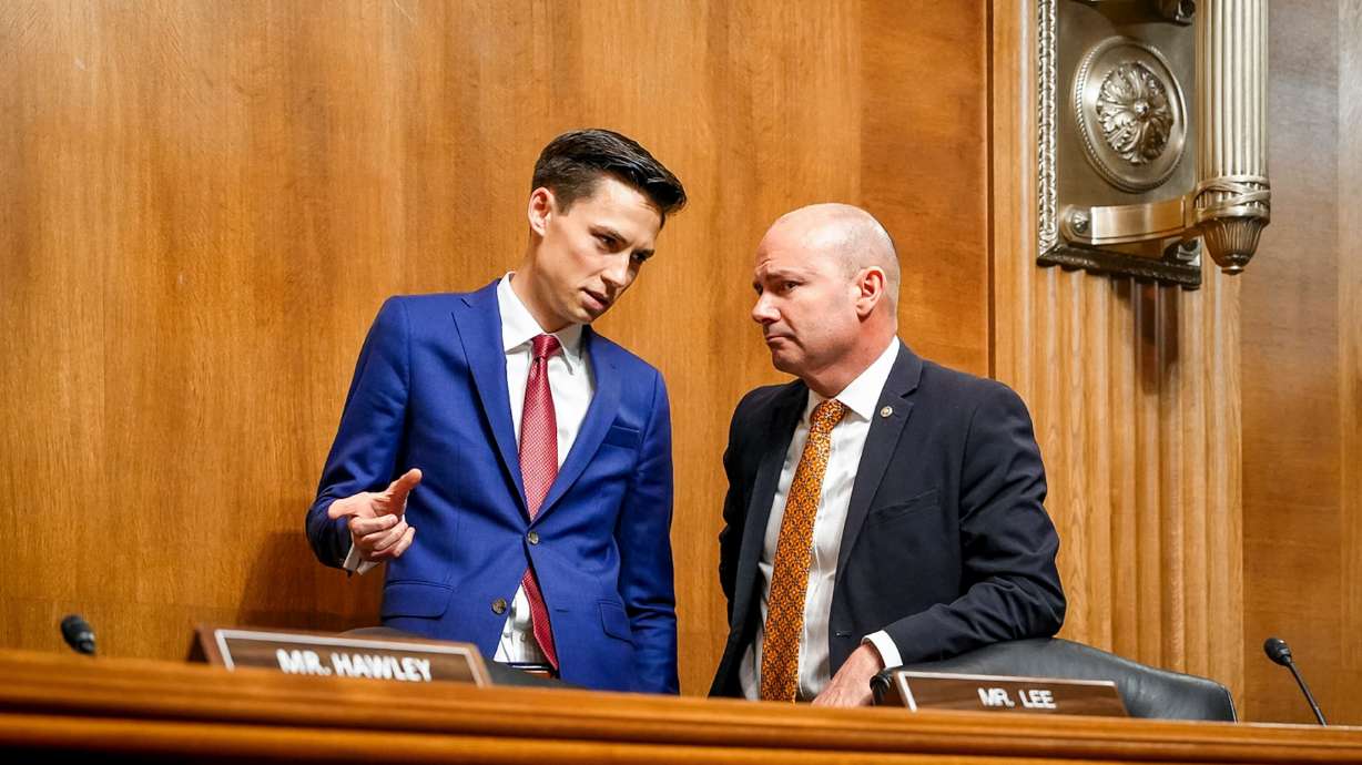 Mark Wait, left, chief of staff to Sen. Mike Lee, R-Utah, talks with Lee in the Dirksen Committee Hearing Room in Washington, D.C., on June 24. Wait is one of the youngest chiefs of staff in U.S. Senate history.