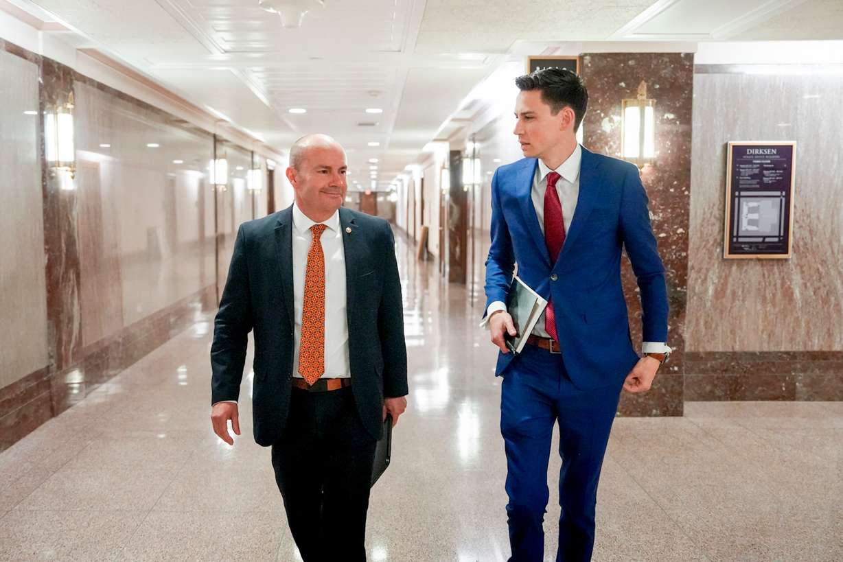 Mark Wait, right, chief of staff to Sen. Mike Lee, R-Utah, talks with Lee as they walk in the Dirksen Senate Office Building in Washington, D.C., on June 24.
